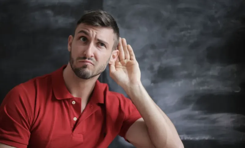 Person meditating with closed eyes wearing stereo headphones for relaxing audio